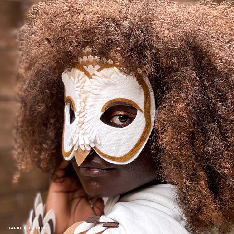 Cream and brown felt barn owl mask worn with an owl costume.