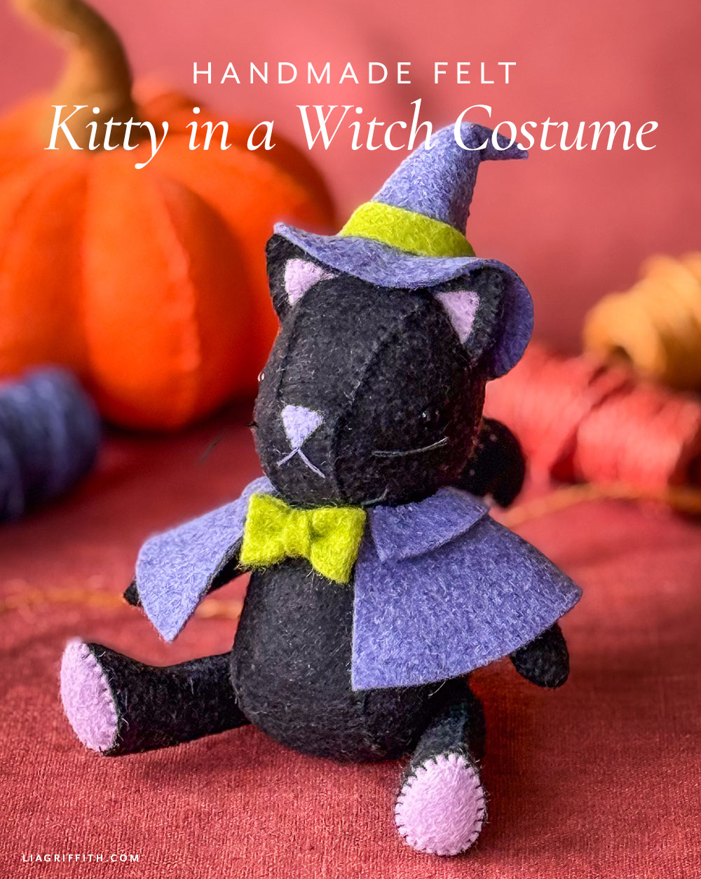 Felt black cat in a purple witch hat and cape