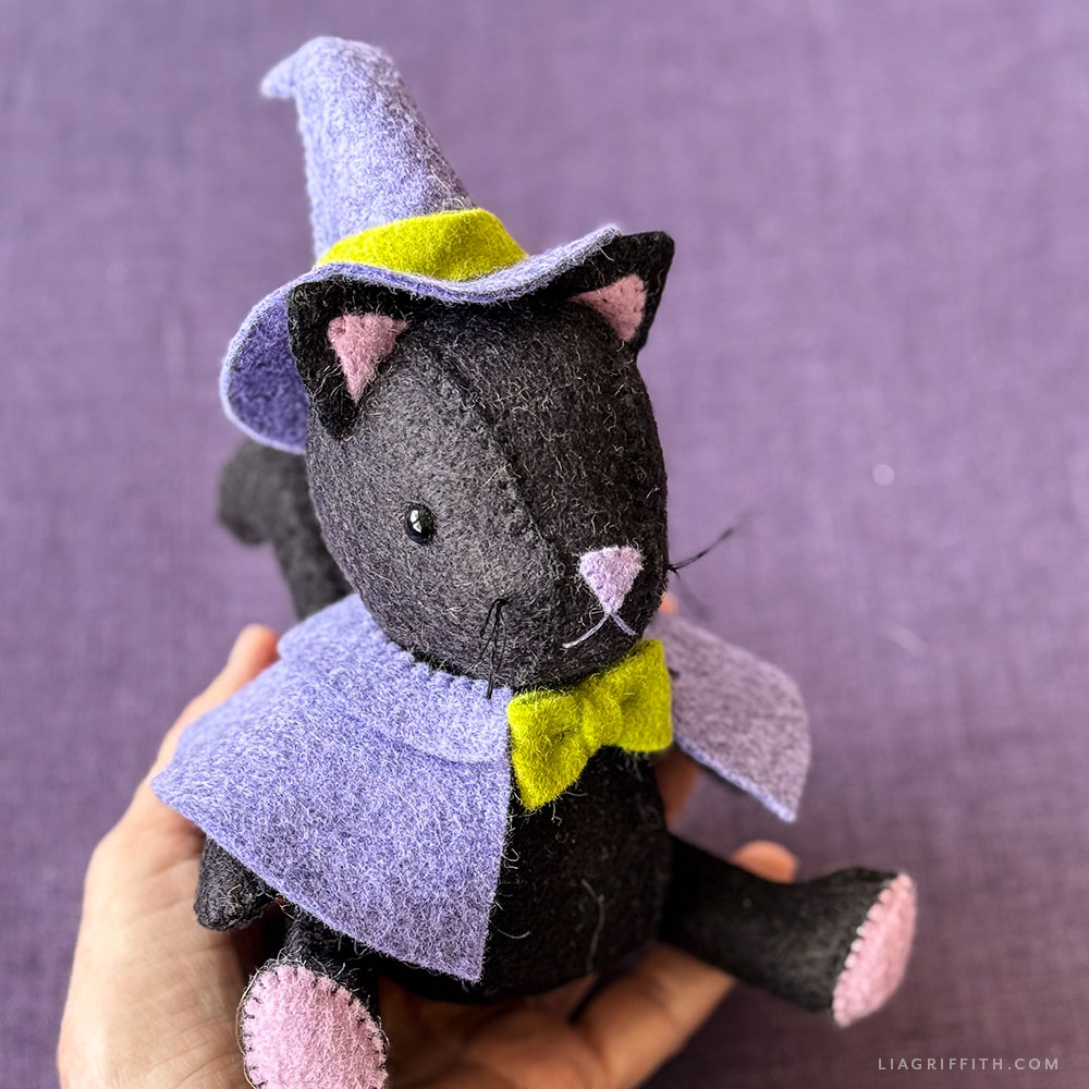 Felt black cat in a purple witch hat and cape