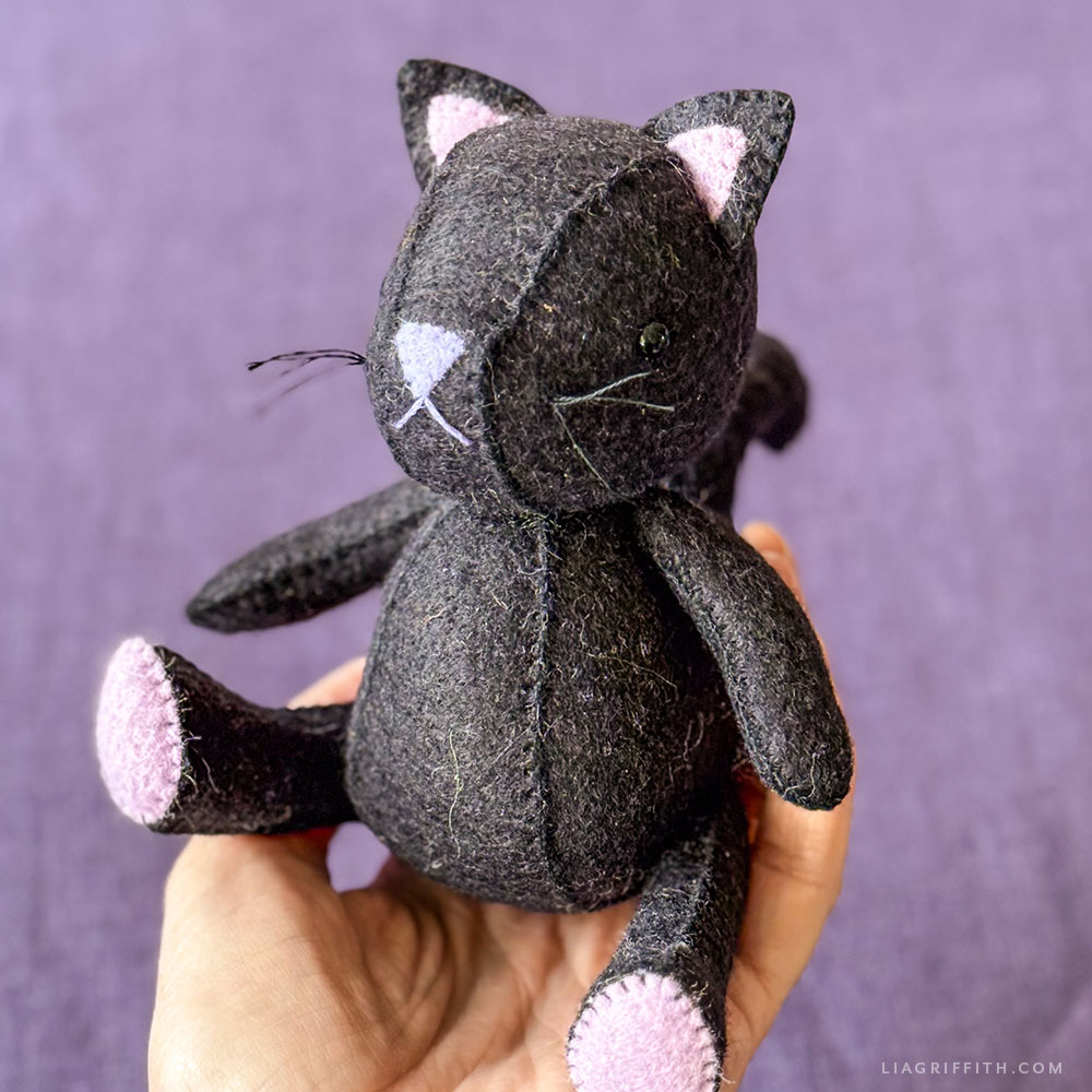 Felt black cat in a purple witch hat and cape